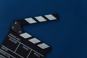 Fototapeta na wymiar Movie clapper board on classic blue background. Filmmaking, Movie production, Entertainment industry. Color 2020. Top view