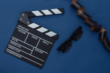 Movie clapper board with film tape, 3d glasses on classic blue background. Filmmaking, Movie...