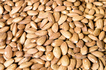 Almonds as a very stylish background of natural products in a beautiful color.