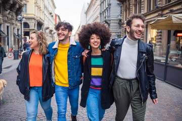 Group of friends socialising strolling hugging - Diverse multiethnic perople outdoor walking having fun hugging - togetherness, fooling around, positive concept