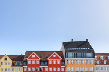 Colorful houses in yellow, red and orange of the Nyhaven in Copenhagen Denmark photographed...