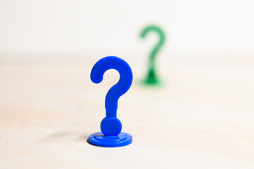 Problem solving and leadership illustrated with play figures in question mark shape in bright...