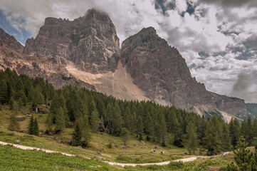 Fototapeta na wymiar Monte Pelmo, an impressive and isolated mountain as seen from Rifugio Cima di Fiume at the end of stage six of Alta Via 1 classic trek in the Dolomites, province of Belluno, South Tirol, Italy.