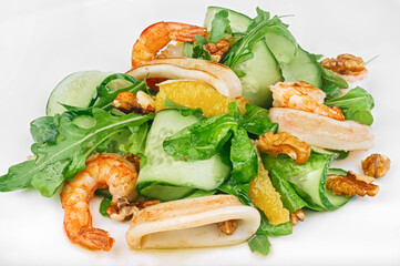 Raw seafood green salad with shrimps, squid rings and walnut