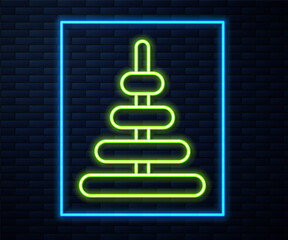 Glowing neon line Pyramid toy icon isolated on brick wall background. Vector.