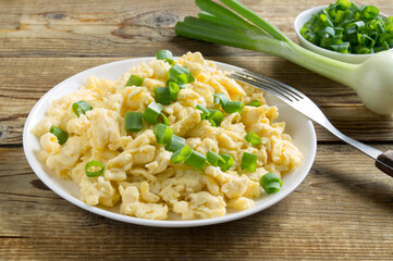 scrambled eggs on a white plate.