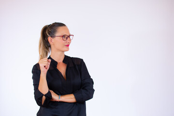 Obraz premium Pretty businesswoman with glasses and black blouse smiling
