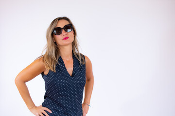 Beautiful woman in blue shirt and sunglasses posing