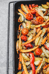 Grilled vegetables salad with zucchini, eggplant, peppers and tomato on grey background