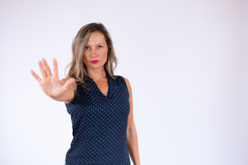 Woman in blue shirt making the stop gesture