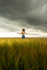 young woman in the field, practicing yoga and meditation. destressing.