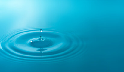 Close-up blue water drops isolated on white background.