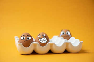eggs with facial expressions on a yellow background.