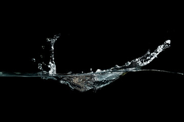 close up of water waves splash and bubbles isolated on black background.