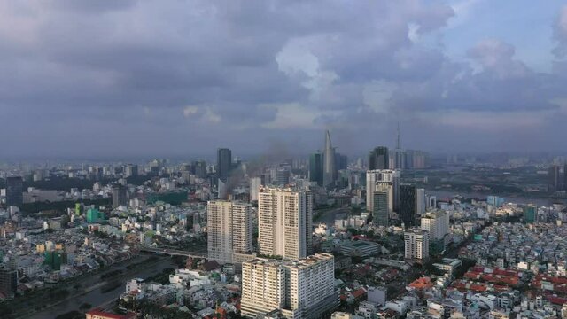 tracking drone shot of business district of Ho Chi Minh City, the business capital of Vietnam with impressive architecture and infrastructure taken in afternoon light