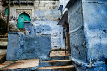 View of a street in Jodhpur with the facades of houses painted blue. Rajasthan. India