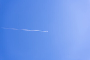 clear blue sky background with a plane. tone blue background. tone blue wallpaper.