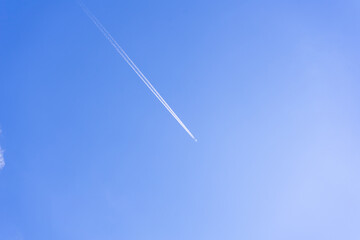 clear blue sky background with a plane. tone blue background. tone blue wallpaper.