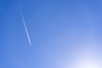 clear blue sky background with a plane. tone blue background. tone blue wallpaper.