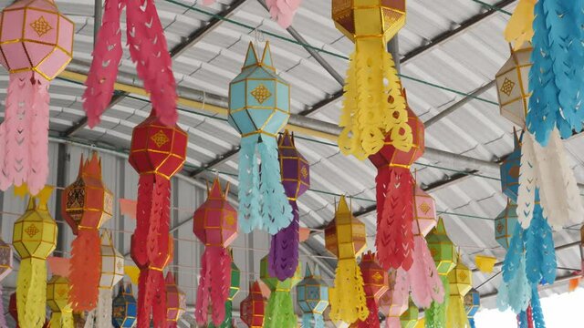4K Colorful paper ceiling lanterns swaying by wind as vintage interier background.