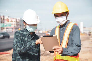 Engineering holding tablet for work on road construction, Focus on hand and tablet