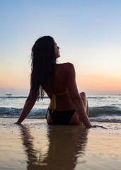 Fototapeta na wymiar Woman in swiming suit posing on the beach