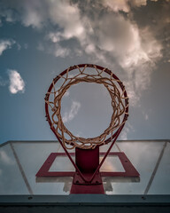 basketball under beautiful summer sunlight with clouds background - obrazy, fototapety, plakaty