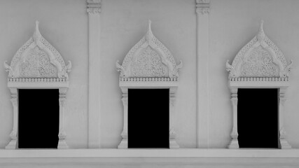 window on white wall of temple in black and white tone.