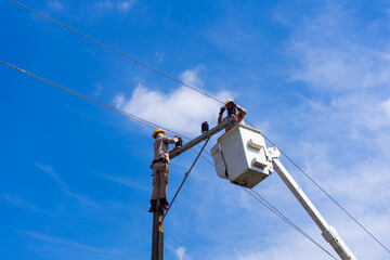 Obraz premium electrician people work installation of high voltage on pole. Engineers working with high voltage hazards