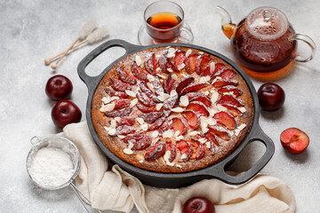 Plum pie on wooden background. Autumn plum cake