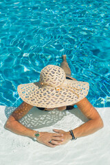 woman in luxury spa resort near the swimming pool.