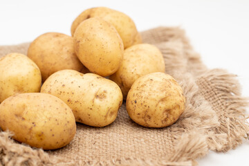Fototapeta na wymiar Fresh organic potatoes on sackcloth. Raw potato