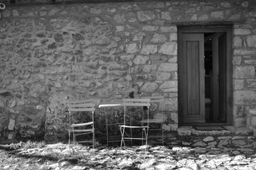 Fototapeta na wymiar Table in front of an old house (black & white)