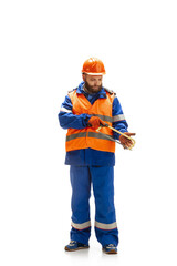 Handsome contractor, builder isolated over white studio background. Concept of professional occupation, work, job, building, investment. Copyspace for ad, text. Caucasian man wearing equipment.
