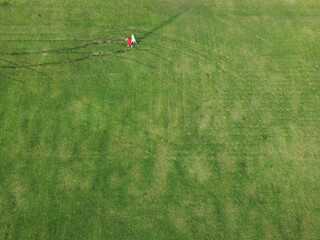 Aerial view of people walking on the lawn in the park