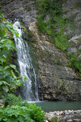 Fototapeta na wymiar High mountain with a waterfall.Mountain landscape in summer