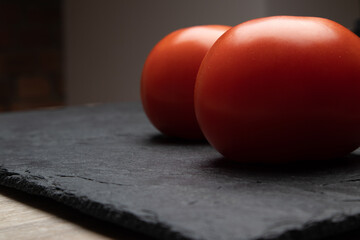 Beautiful natural tomatoes on a black background