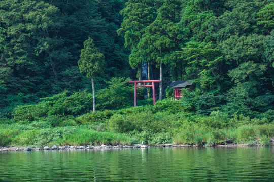 Shiraito Falls with red torii is superb view of Mogami River valley in Yamagata, Japan