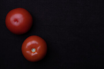 Beautiful natural tomatoes on a black background