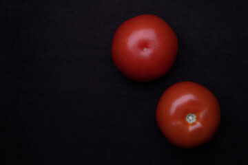 Beautiful natural tomatoes on a black background