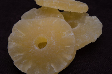 Dry pineapples on a dark background. Beautiful background. Dried fruits