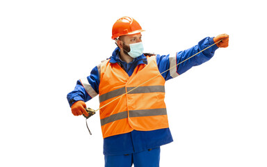 Handsome contractor, builder in face mask isolated over white studio background. Concept of professional occupation, work, job, building, investment. Copyspace for ad, text. Caucasian man wearing