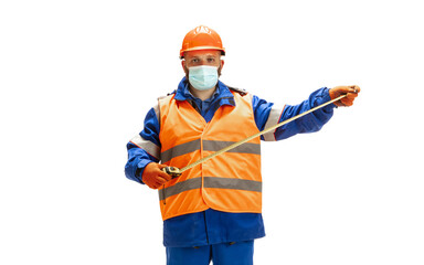Handsome contractor, builder in face mask isolated over white studio background. Concept of professional occupation, work, job, building, investment. Copyspace for ad, text. Caucasian man wearing