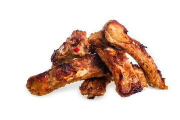 Sliced baked pork ribs piled in a pile on a white background, isolate