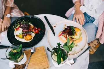 From above picture of healthy delicious dish in restaurant menu with organic ingredients and spices, top view of modern cuisine with colorful veggie meal vegetables and tomatoes