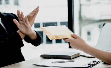 Government officials refusing money to take the bribe money from business man the concept of...
