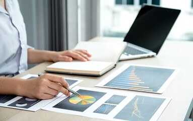 Businesswoman analysis the chart with laptop at the office for setting challenging business goals And planning to achieve the new target