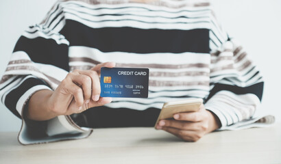 Businesswoman hand holding credit card to online shopping from home, payment e-commerce, internet banking, spending money for next holidays