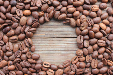 Coffee beans frame on wooden background with copy space