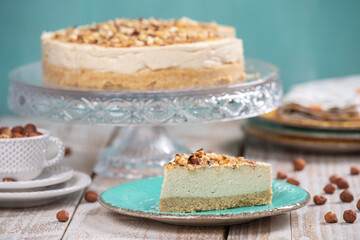 Cheese cake with hazelnuts on wood background